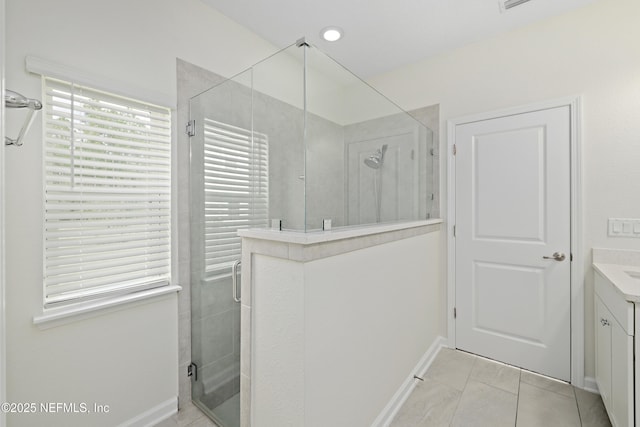 bathroom with a stall shower and vanity