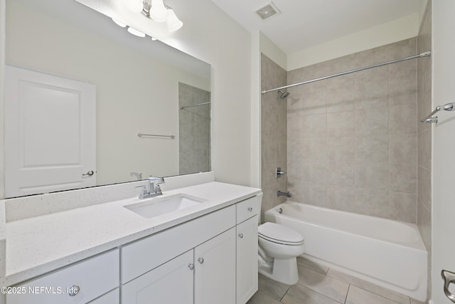 bathroom featuring tile patterned floors, visible vents, toilet, bathing tub / shower combination, and vanity