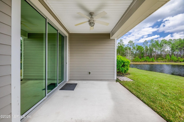 view of patio featuring ceiling fan and a water view