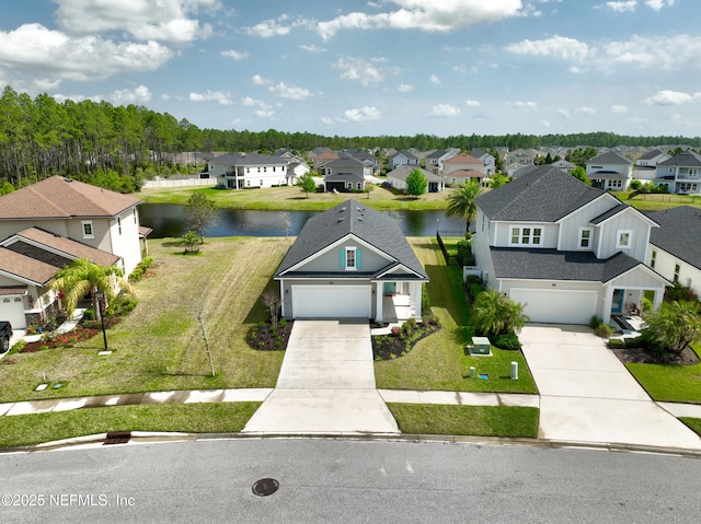 drone / aerial view with a residential view and a water view