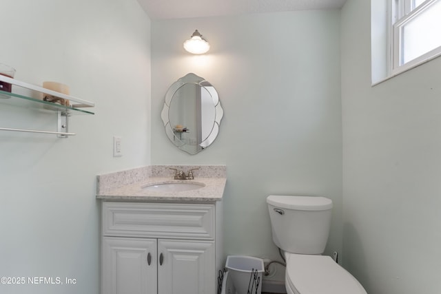 bathroom featuring vanity and toilet