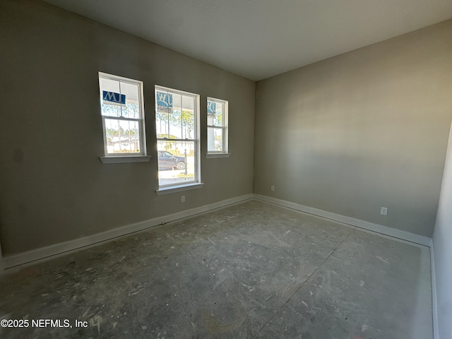 spare room with baseboards