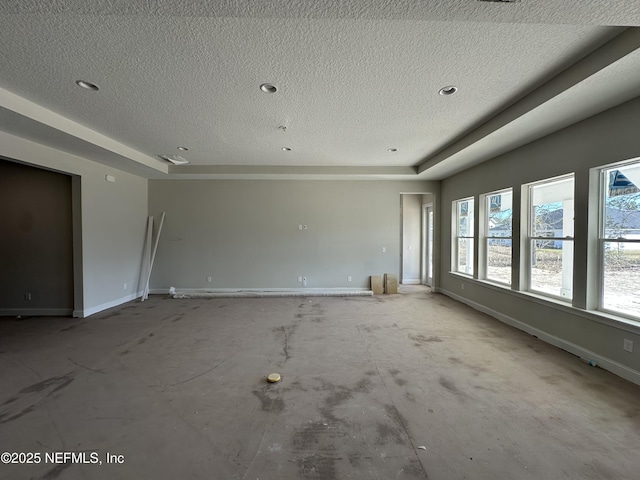 unfurnished room featuring baseboards and a textured ceiling