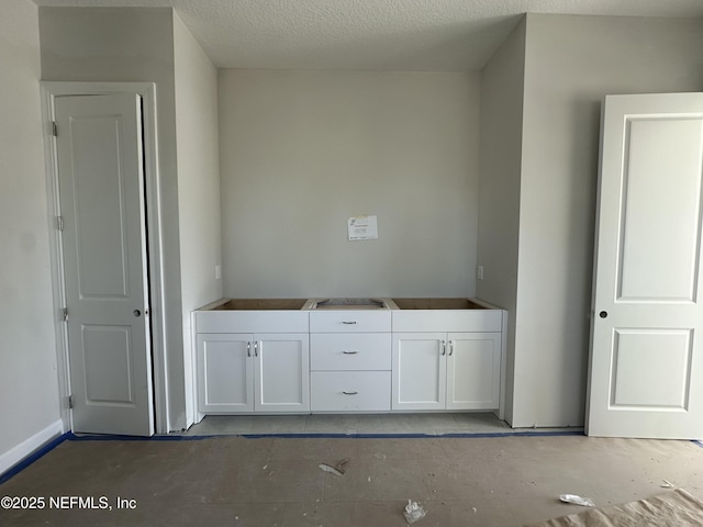 interior space featuring a sink and a textured ceiling