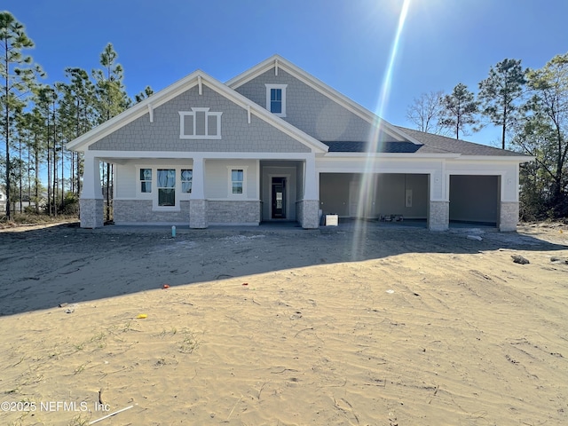 view of front of home featuring stone siding and an attached garage