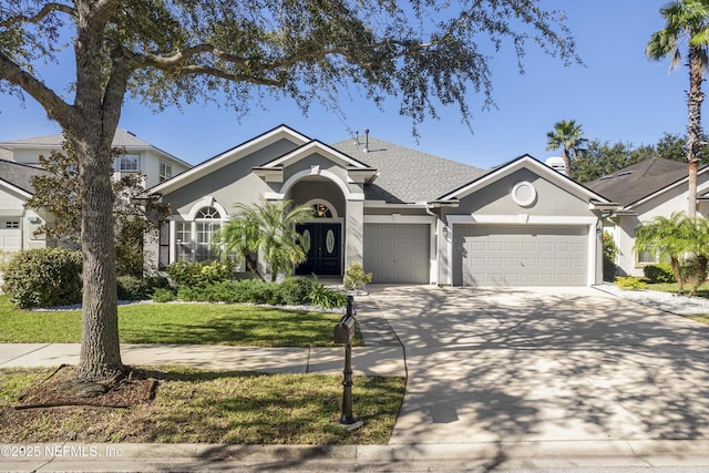 view of front of property with a garage and a front yard