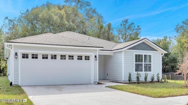 ranch-style home featuring a garage and a front lawn