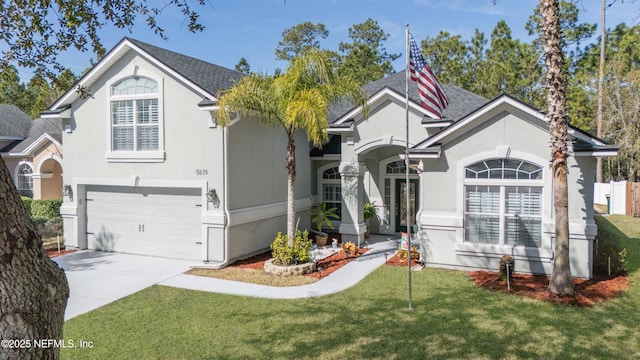 view of front of property with a garage and a front lawn