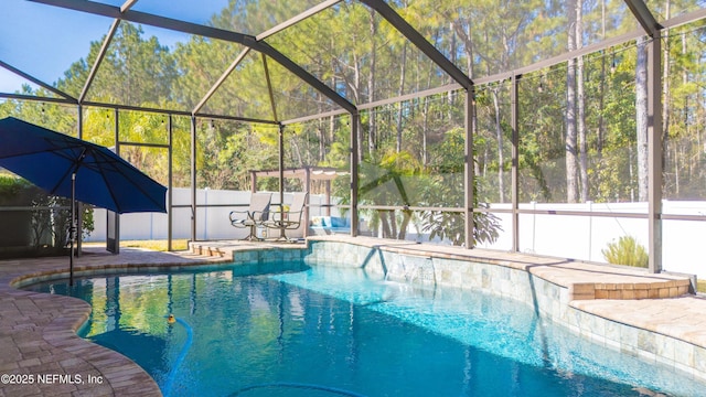 view of swimming pool featuring a patio and glass enclosure