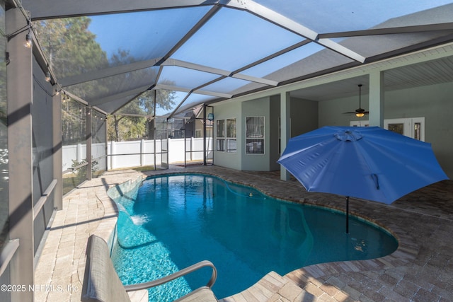 view of pool with a patio, a lanai, and ceiling fan