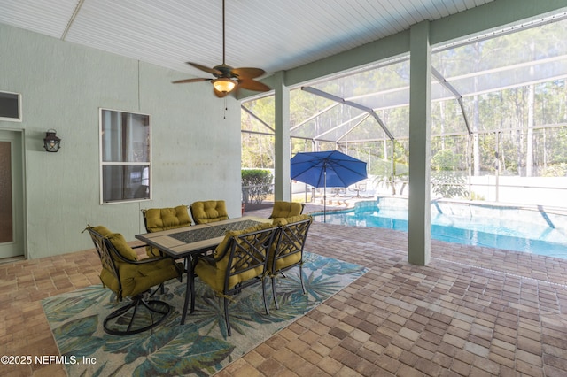 view of patio / terrace with outdoor lounge area, ceiling fan, and glass enclosure