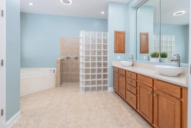 bathroom featuring tile patterned floors, separate shower and tub, and vanity