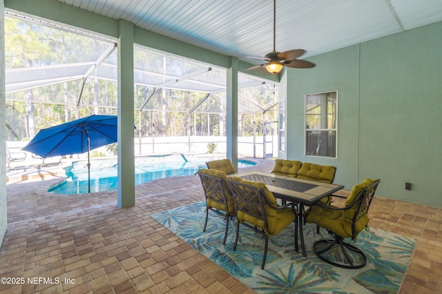 sunroom featuring ceiling fan