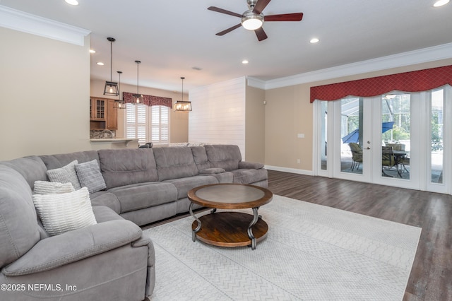 living room with crown molding, ceiling fan, and hardwood / wood-style flooring