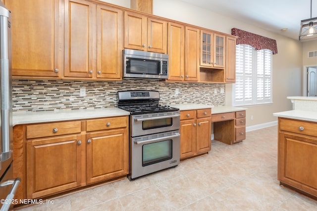 kitchen with decorative backsplash, appliances with stainless steel finishes, hanging light fixtures, and light tile patterned floors