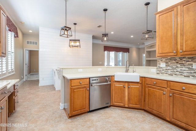 kitchen with tasteful backsplash, sink, hanging light fixtures, kitchen peninsula, and crown molding