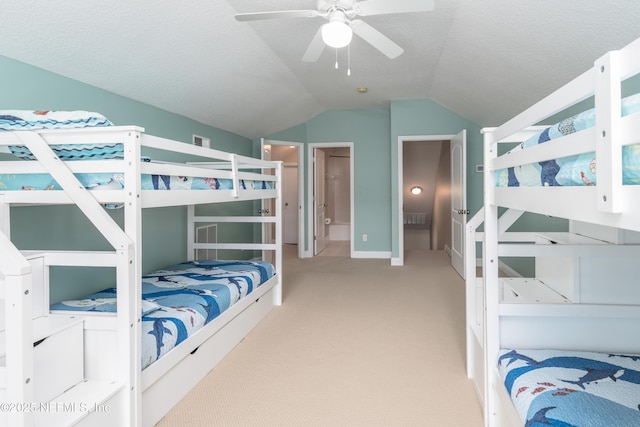 carpeted bedroom featuring ceiling fan, vaulted ceiling, and a textured ceiling