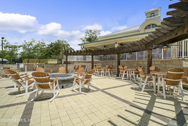 view of patio / terrace with an outdoor fire pit and a pergola