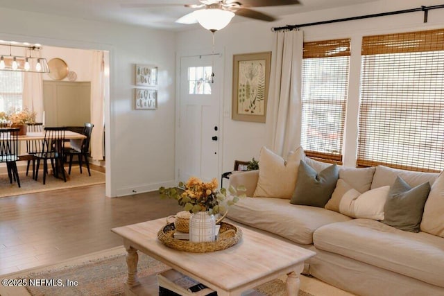 living room featuring hardwood / wood-style floors and ceiling fan