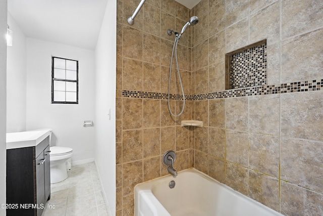 full bathroom with toilet, tile patterned floors, vanity, and tiled shower / bath