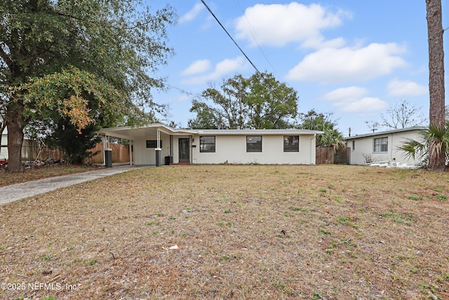 ranch-style home featuring a carport and a front yard