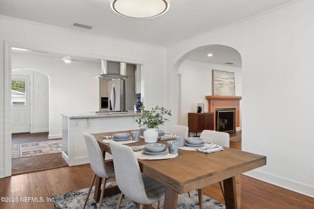 dining room featuring wood-type flooring and crown molding