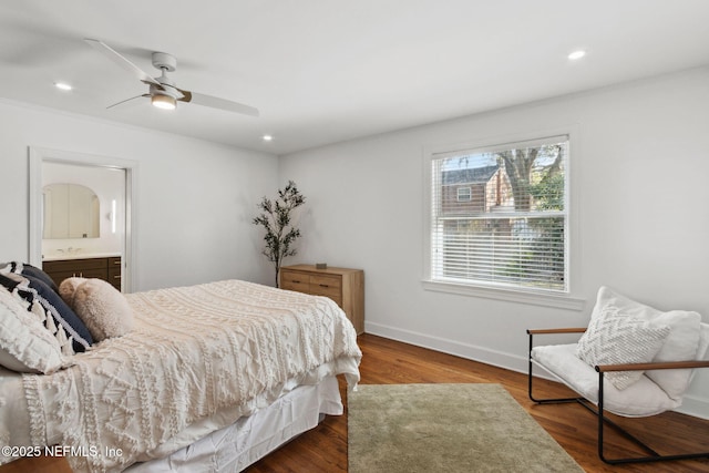 bedroom featuring ceiling fan, dark hardwood / wood-style flooring, and ensuite bath