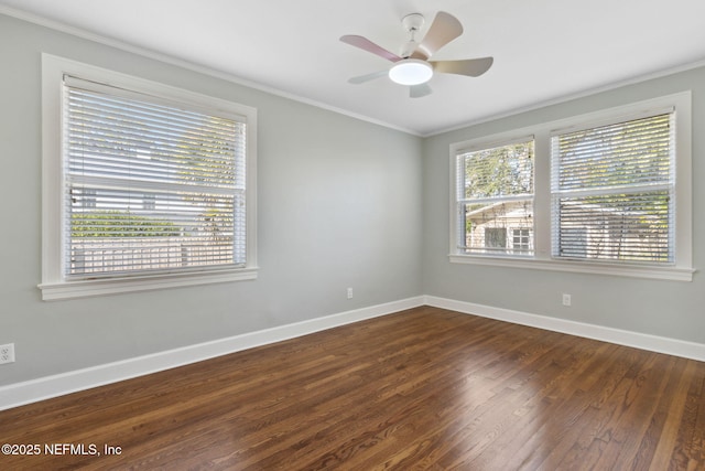 empty room featuring ceiling fan, ornamental molding, and dark hardwood / wood-style flooring