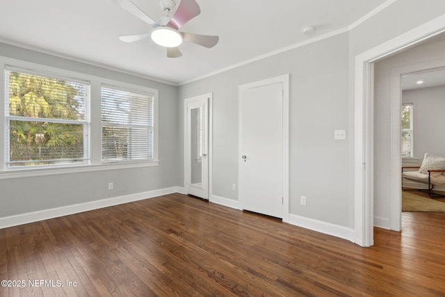 unfurnished bedroom featuring dark wood-type flooring, ornamental molding, and ceiling fan