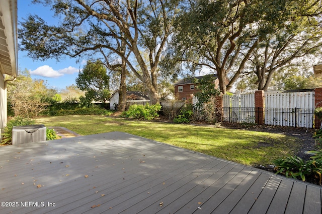 wooden terrace featuring a yard