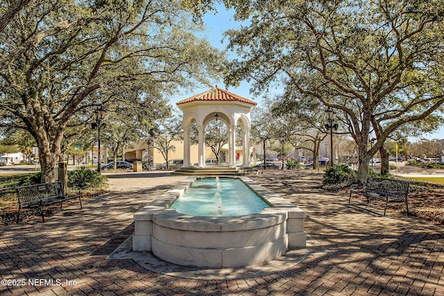 view of swimming pool with pool water feature