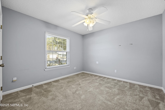 spare room featuring ceiling fan, carpet flooring, and a textured ceiling