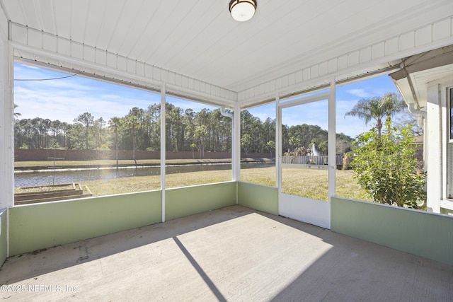 unfurnished sunroom with a water view