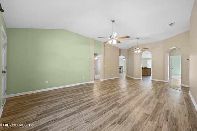 unfurnished living room featuring vaulted ceiling, ceiling fan, and hardwood / wood-style floors