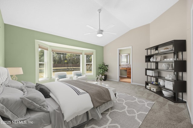 bedroom featuring lofted ceiling, light colored carpet, connected bathroom, and ceiling fan