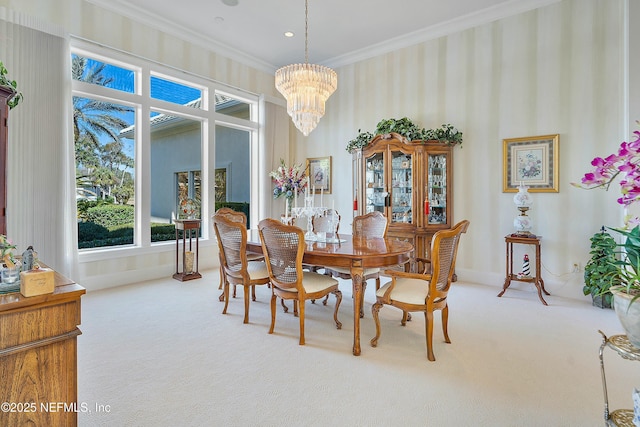 dining space featuring crown molding, a chandelier, carpet floors, and a high ceiling