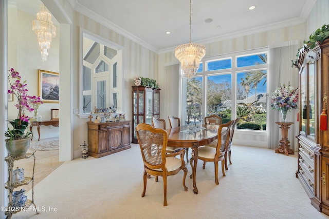 carpeted dining area with a towering ceiling, ornamental molding, and a notable chandelier