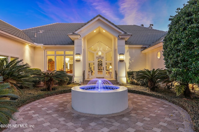 exterior entry at dusk with french doors