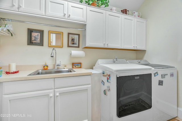 laundry room featuring cabinets, sink, and independent washer and dryer