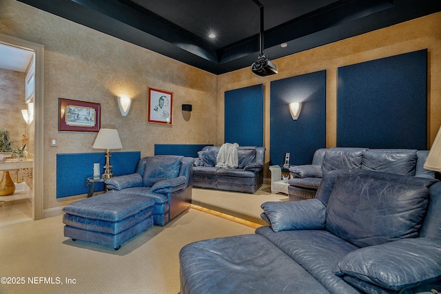 carpeted home theater with a tray ceiling