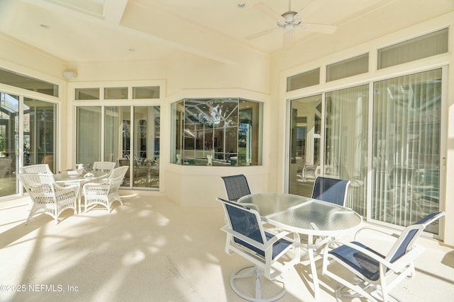 sunroom / solarium featuring ceiling fan