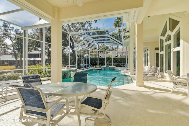 view of pool with a patio and glass enclosure