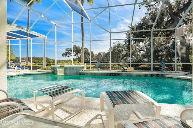 view of pool featuring a patio area and glass enclosure