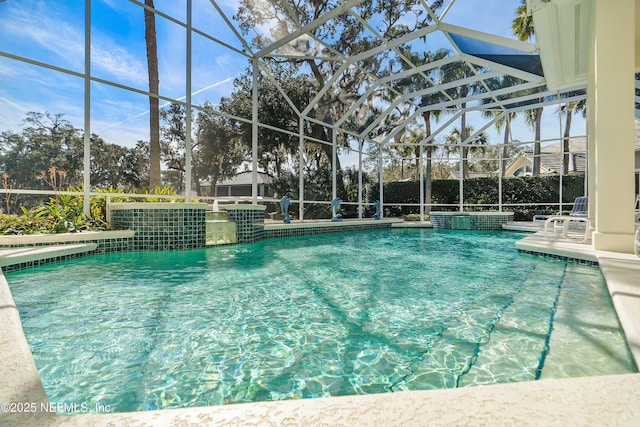 view of swimming pool featuring pool water feature and glass enclosure