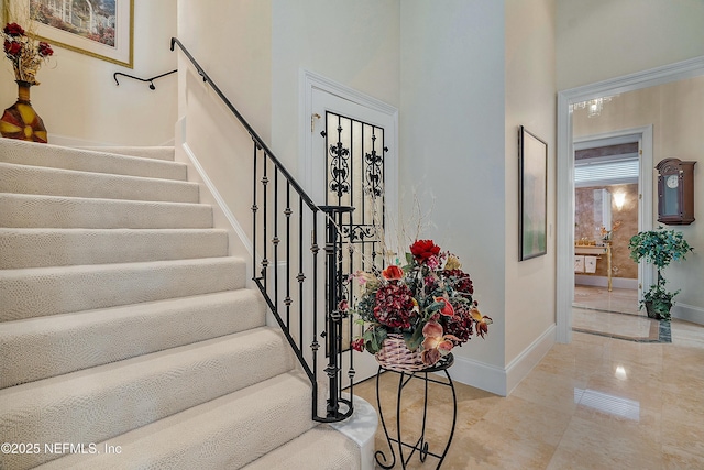 stairs featuring a towering ceiling