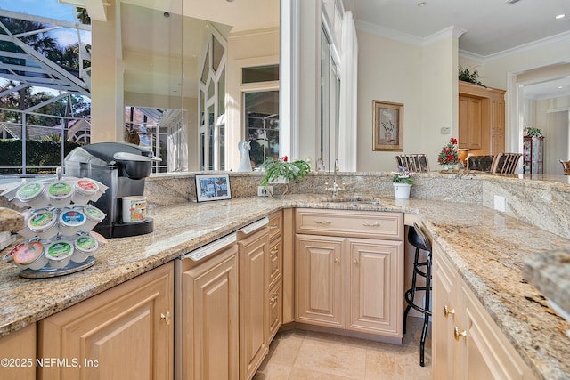 kitchen featuring crown molding, light stone countertops, sink, and light brown cabinets