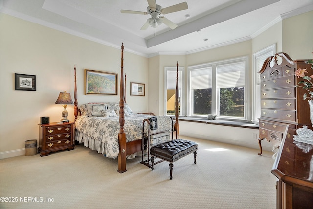 carpeted bedroom featuring ceiling fan, ornamental molding, and a tray ceiling