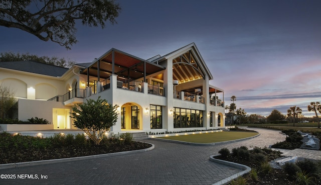 exterior space featuring a balcony and stucco siding