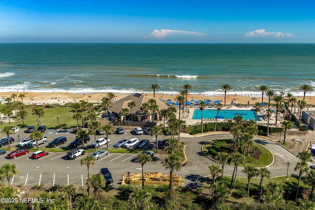 birds eye view of property with a beach view and a water view
