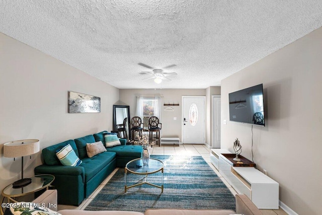 tiled living room with a textured ceiling and ceiling fan